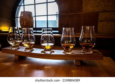 Flight Of Single Malt Scotch Whisky In Glasses Served In Bar In Edinburgh, UK, Tasting Of Dram Of Whiskey