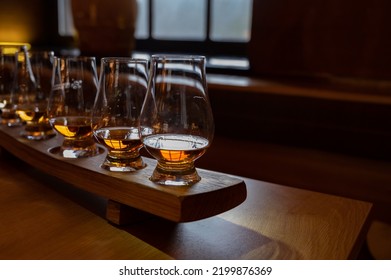 Flight Of Single Malt Scotch Whisky In Glasses Served In Bar In Edinburgh, UK, Tasting Of Dram Of Whiskey