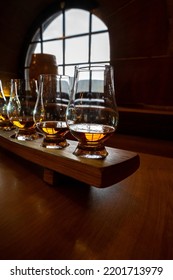 Flight Of Single Malt Scotch Whisky In Glasses Served In Bar In Edinburgh, UK, Tasting Of Dram Of Whiskey