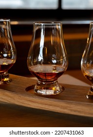 Flight Of Single Malt Scotch Whisky In Glasses Served In Bar In Edinburgh, UK, Tasting Of Dram Of Whiskey