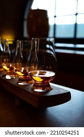 Flight Of Single Malt Scotch Whisky In Glasses Served In Bar In Edinburgh, UK, Tasting Of Dram Of Whiskey