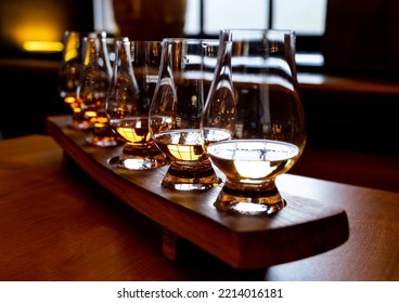 Flight Of Single Malt Scotch Whisky In Glasses Served In Bar In Edinburgh, UK, Tasting Of Dram Of Whiskey