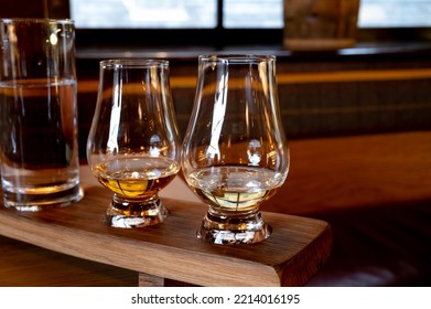 Flight Of Single Malt Scotch Whisky In Glasses Served In Bar In Edinburgh, UK, Tasting Of Dram Of Whiskey