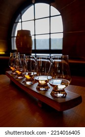 Flight Of Single Malt Scotch Whisky In Glasses Served In Bar In Edinburgh, UK, Tasting Of Dram Of Whiskey