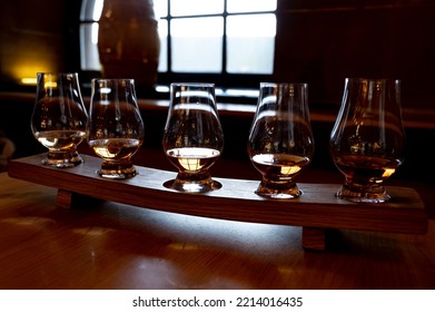 Flight Of Single Malt Scotch Whisky In Glasses Served In Bar In Edinburgh, UK, Tasting Of Dram Of Whiskey