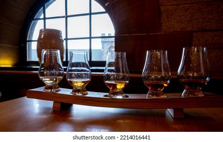 Flight Of Single Malt Scotch Whisky In Glasses Served In Bar In Edinburgh, UK, Tasting Of Dram Of Whiskey