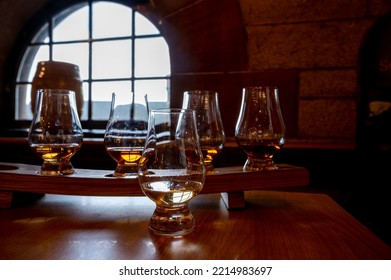 Flight Of Single Malt Scotch Whisky In Glasses Served In Bar In Edinburgh, UK, Tasting Of Dram Of Whiskey