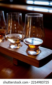 Flight Of Single Malt Scotch Whisky In Glasses Served In Bar In Edinburgh, UK, Tasting Of Dram Of Whiskey