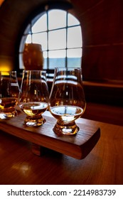 Flight Of Single Malt Scotch Whisky In Glasses Served In Bar In Edinburgh, UK, Tasting Of Dram Of Whiskey