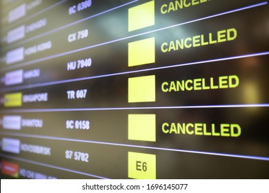 Flights Cancelled And Delayed On Airport Departure Board Due To Covid-19 Pandemic. Coronavirus Causing Disruption In Air Transport With Airlines Cancelling Service. Travel And Vacation Cancellation