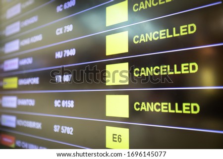 Flights cancelled and delayed on airport departure board due to covid-19 pandemic. Coronavirus causing disruption in air transport with airlines cancelling service. Travel and vacation cancellation