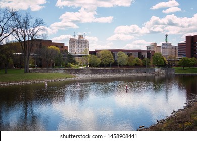 Flint, Michigan - May 14, 2019: Flint, Michigan Skyline And The Flint River. Known Widely For Their Water Quality And Safety Issues. Shot In On A Beautiful Spring Day.