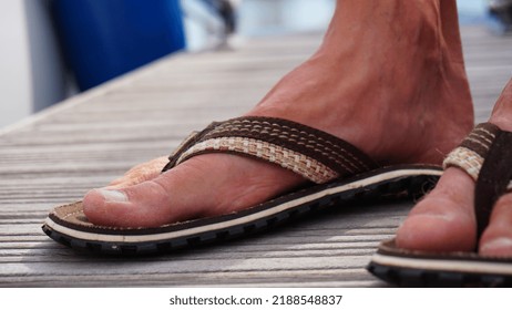 Flip Flop With Man Foot. Summer Shoes With Bare Feet. Flip Flops For Warm Days And Holiday Walks In The Great Outdoors.