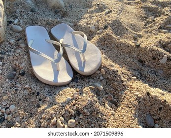 Flip Flop Sandals On Snow White Sand.