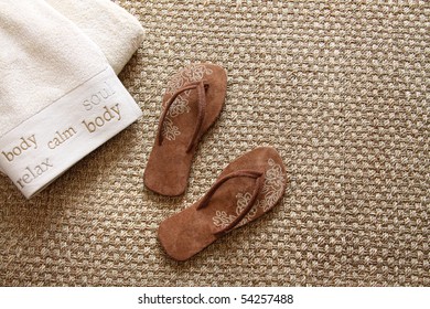 Flip Flops With Fluffy Towels On Sea-grass Rug