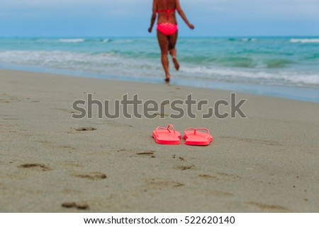 flip flops and happy woman running to swim at beach