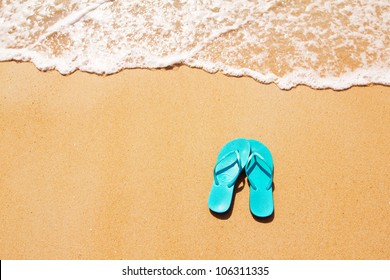 Flip Flops On A Sandy Ocean Beach