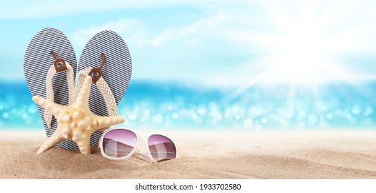 Flip flops, starfish and sunglasses on sunny sea beach with copy space. Travel vacation concept - Powered by Shutterstock