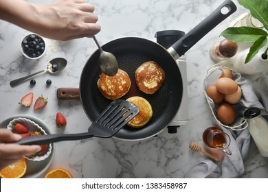 Flip the pancakes with a spatula. Concept of Cooking ingredients and method on white marble background, Dessert recipes and homemade. - Powered by Shutterstock