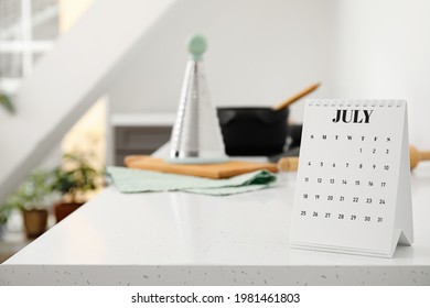 Flip Paper Calendar On Table In Kitchen