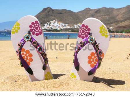Flip-flops in the sand of Teresitas beach. Tenerife island, Canaries