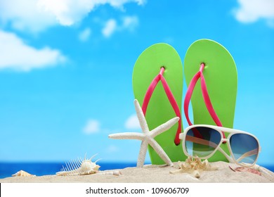 Flip-flops,sunglasses with starfish on beach - Powered by Shutterstock