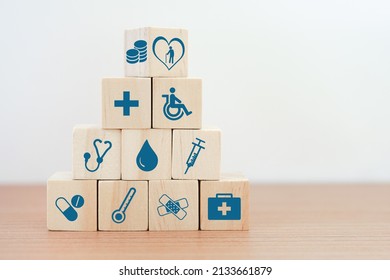 Flipped Wood Cube Block On Top Of Pyramid With Health And Medical Icon, Elderly In Heart And Money Symbol On Top For Retirement, Elderly Care, Health And Medical Concept