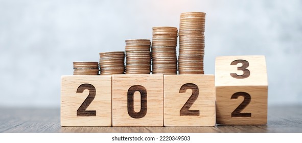 flipping 2022 to 2023 year block with Coins stack. Money, Budget, tax, investment, financial, savings and New Year Resolution concepts - Shutterstock ID 2220349503