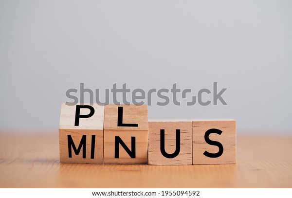 Flipping of\
minus to plus  which print screen on wooden cube block ,Positive\
and negative thinking and mindset\
concept.
