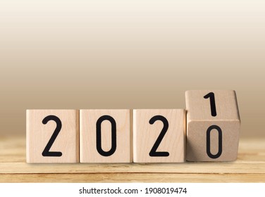 Flipping wooden blocks for the change year 2020 to 2021. A new year and holiday concept.