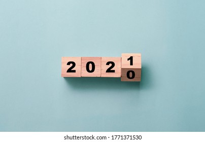 Flipping of wooden cubes block to change 2020 to 2021 year. Merry Christmas and happy new year concept.
