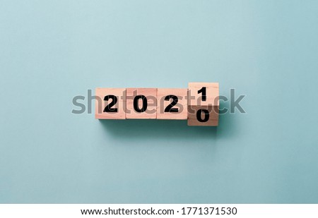 Flipping of wooden cubes block to change 2020 to 2021 year. Merry Christmas and happy new year concept.