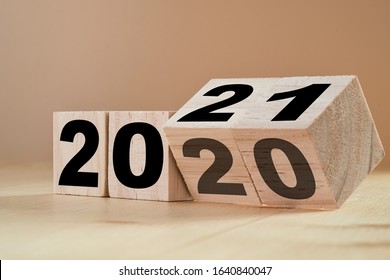 Flipping Wooden Cubes For New Year Change 2020 To 2021. New Year Change And Starting Concept.