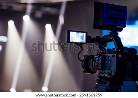 Flip-up screen of a professional video camera. The image is out of focus. Shooting holidays and concerts.