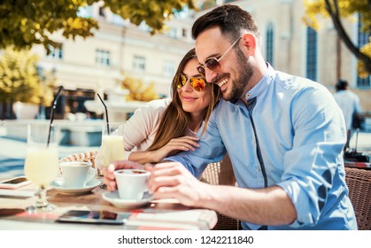 Flirting in a cafe. Beautiful loving couple sitting in a cafe drinking coffee and enjoying in conversation. Love, romance, dating - Powered by Shutterstock