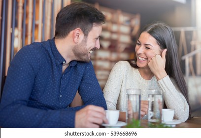 Flirting in a cafe. Beautiful loving couple sitting in a cafe enjoying in coffee and conversation. Love and romance.  - Powered by Shutterstock