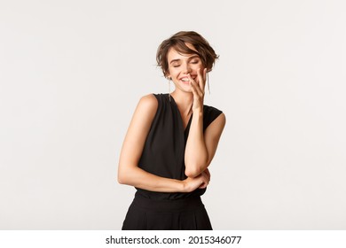 Flirty Beautiful Woman Giggle And Cover Smile With Hand, Acting Coquettish Over White Background