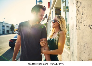 Flirty Romantic Couple Walking Together On Los Angeles Sidewalk