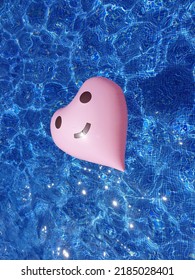 A Floarting Heart Tube In The Sparkling Pool