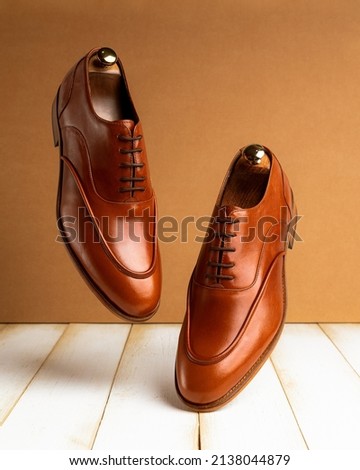 float classic light brown Leather shoes on wood