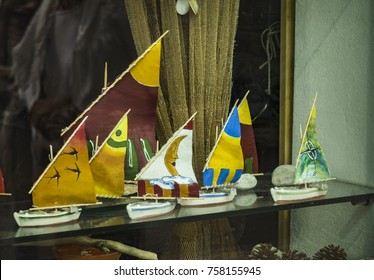 A float of colored model of little boat on a windows