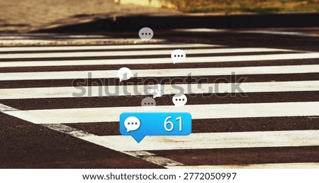 Floating blue chat bubble displaying 61 on zebra crosswalk, with white and gray speech icons. Digital, notification, urban, sidewalk, asphalt, sunlit, goldenhour