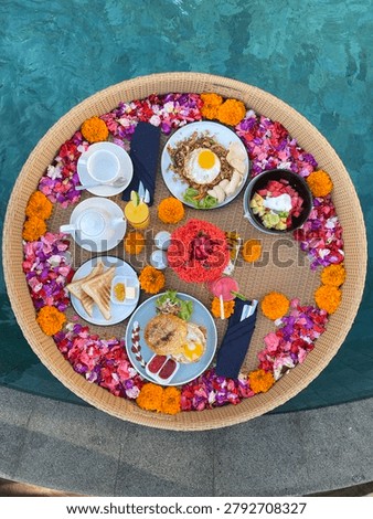 A floating breakfast is a luxurious dining experience where a sumptuous meal is served on a large, buoyant tray that floats directly on a swimming pool's water