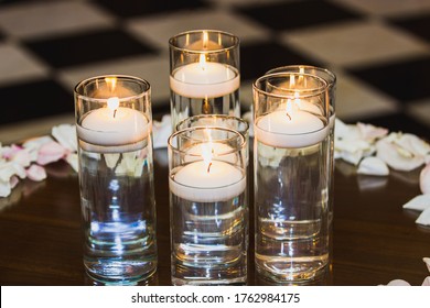Floating Candle Centerpiece Sitting On A Table