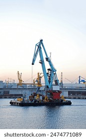 Floating cargo crane over sunset sky background in Odessa, Ukraine