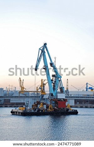Floating cargo crane over sunset sky background in Odessa, Ukraine
