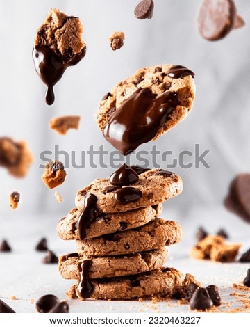 Floating chocolate cookies with melted chocolate on top