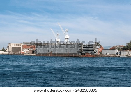 floating dock against the backdrop of a shipyard