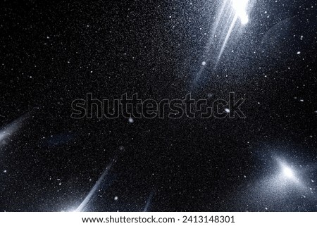 Floating dust particles. White dust texture on a black background with bright rays of light coming through the night sky.	