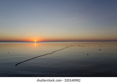 Floating Fish Net In A Calm Bay At Sunset In The Baltic Sea